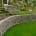 curved retaining wall with green grasss